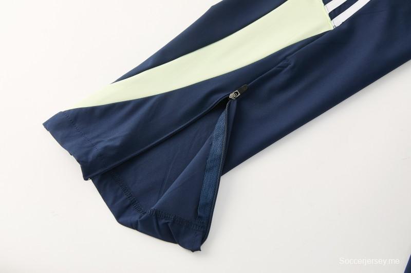 26/27 بدلة رياضية من ريال مدريد باللون الأزرق الداكن مع سترة واقية من الرياح بغطاء للرأس وسحاب كامل + بنطال طويل