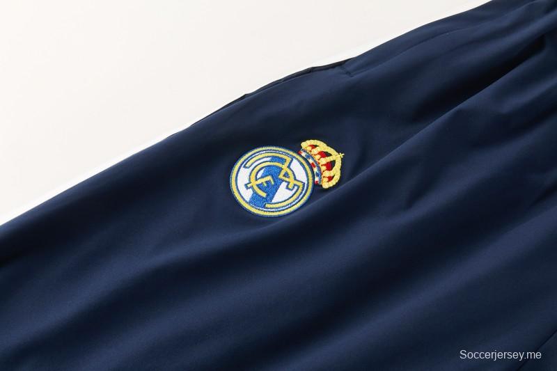 26/27 بدلة رياضية من ريال مدريد باللون الأزرق الداكن مع سترة واقية من الرياح بغطاء للرأس وسحاب كامل + بنطال طويل